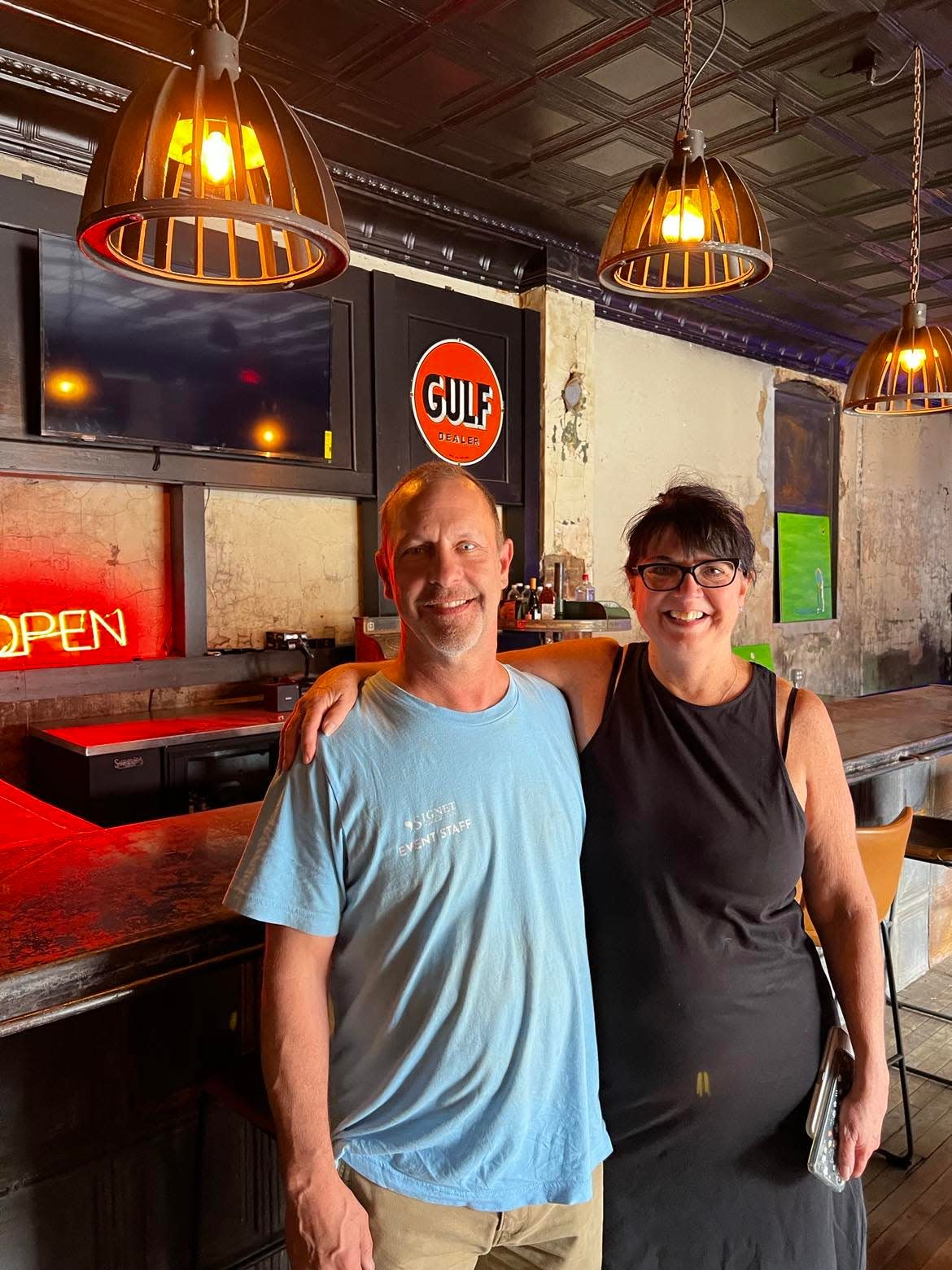 Patrick Huth and Whitney Harris are shown inside Hupp Gulf, a new business in downtown Canton featuring golf simulators, food and drinks. Hupp Gulf expects to open in November.