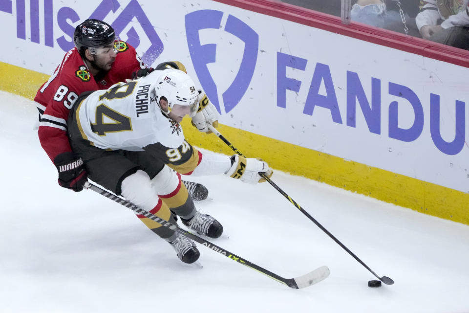 Chicago Blackhawks' Andreas Athanasiou (89) pressures Vegas Golden Knights' Brayden Pachal during the second period of an NHL hockey game Thursday, Dec. 15, 2022, in Chicago. (AP Photo/Charles Rex Arbogast)