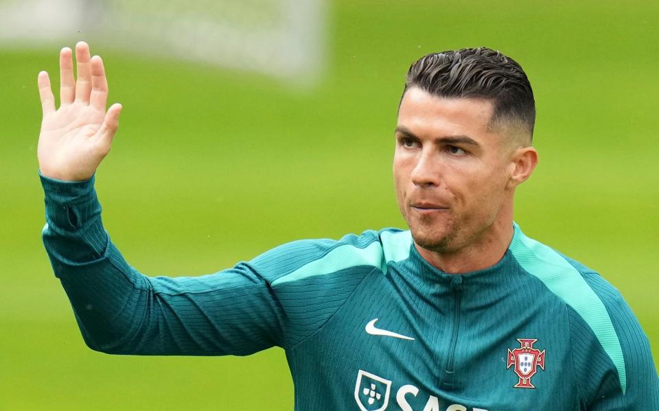 Cristiano Ronaldo waves to the crowd in attendance at a Portugal training session in Gutersloh, Germany