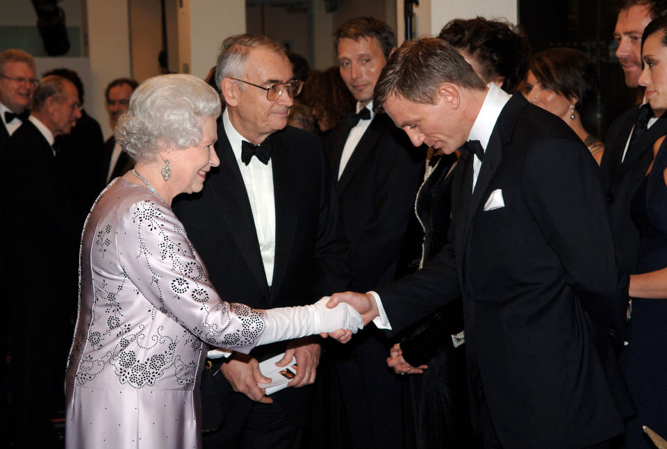Queen Elizabeth II meets actor Daniel Craig,bowing in respect for protocol, at the premiere of the 21st Bond film 'Casino Royale' at the Odeon cinema in Leicester Square. (Photo by © Pool Photograph/Corbis/Corbis via Getty Images)