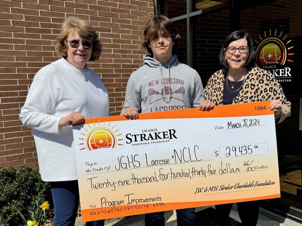 John Glenn junior Cannon Fox, center, accepts a grant check for John Glenn High School Lacrosse and New Concord Youth Lacrosse in the amount of $29,435 from the J.W. and M.H. Straker Charitable Foundation. Representing the Straker Foundation are Pam Kirst, right, and Pam Kuntz, left. Fox, who plays for the Muskies varsity lacrosse team put together the grant proposal and application request for the funds to benefit both programs.