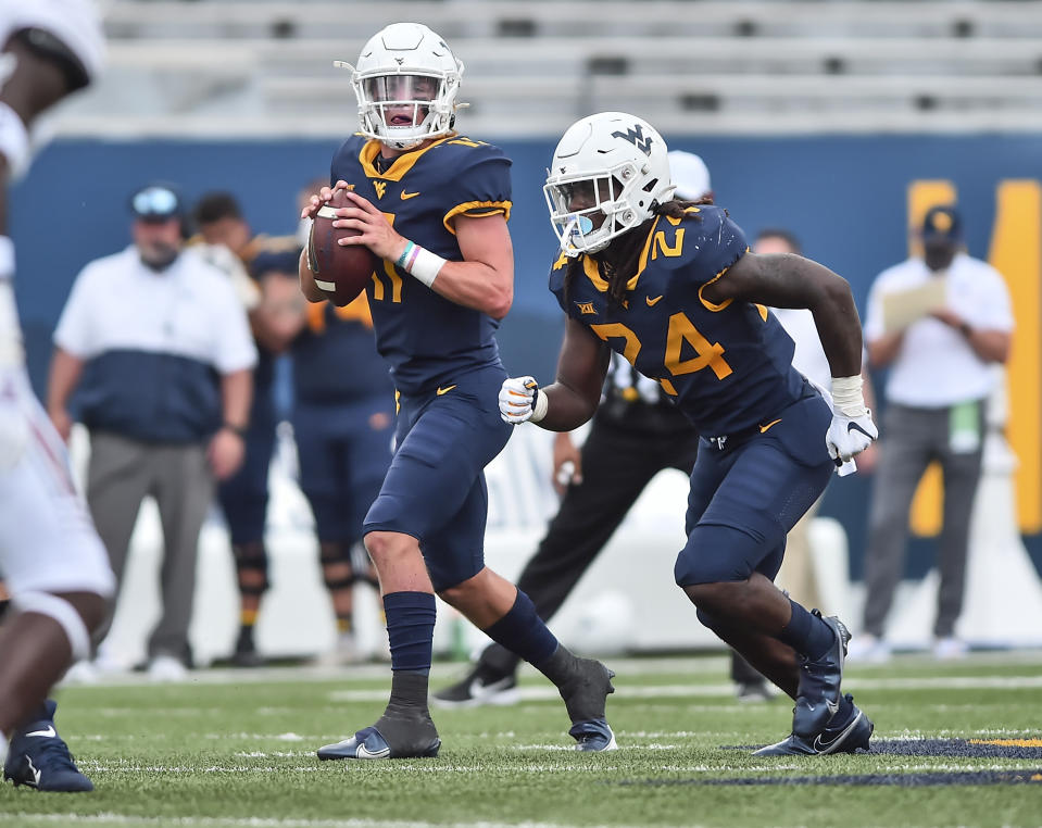 West Virginia quarterback Garrett Greene (11) looks to pass against Eastern Kentucky during an NCAA college football game Saturday, Sept. 12, 2020, in Morgantown, W.Va. (William Wotring/The Dominion-Post via AP)