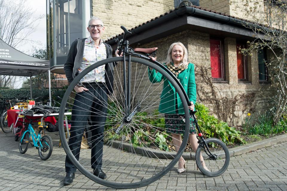 broadcaster jeremy vine and julia cambridge, mayor of the borough of richmond, stand behind the broadcaster's penny farthing bicycle, kew ecofair 2023