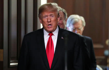 U.S. President Donald Trump arrives followed by Secretary of State Mike Pompeo and U.S. National Security Advisor John Bolton for the annual meeting of the Interagency Task Force to Monitor and Combat Trafficking in Persons at the White House in Washington, U.S., October 11, 2018. REUTERS/Jonathan Ernst