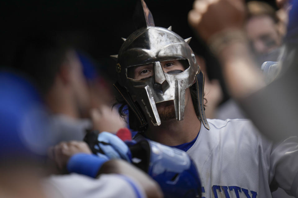 Kansas City Royals' Bobby Witt Jr. wears a Spartan mask in the dugout as he celebrates his home run during the sixth inning of a baseball game against the Chicago Cubs, Friday, Aug. 18, 2023, in Chicago. (AP Photo/Erin Hooley)