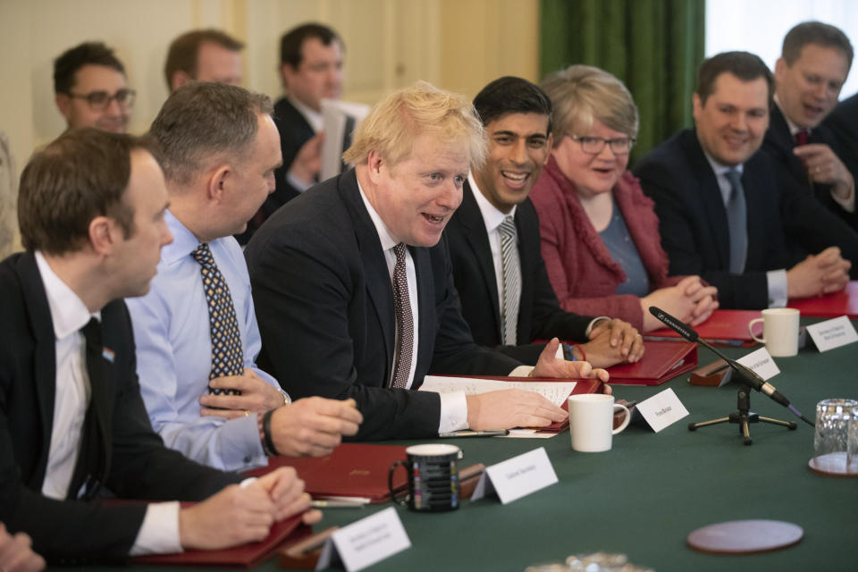 British Prime Minister Boris Johnson speaks during his first Cabinet meeting flanked by his new Chancellor of the Exchequer Rishi Sunak, fourth left, after a reshuffle the day before, inside 10 Downing Street, in London, Friday, Feb. 14, 2020. British Prime Minister Boris Johnson tightened his grip on the government Thursday with a Cabinet shake-up that triggered the unexpected resignation of his Treasury chief, the second-most powerful figure in the administration. (AP Photo/Matt Dunham, Pool)