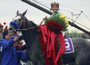 FILE - Jockey Gary Stevens and Silver Charm wear the signature roses in the winner's circle after winning the 123rd Kentucky Derby at Churchill Downs in Louisville, Ky., Saturday, May 3, 1997. (AP Photo/Ed Reinke, File)