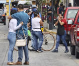 People react after a 7.7 earthquake in Oaxaca, Mexico, Tuesday, June 23, 2020. The earthquake centered near the resort of Huatulco in southern Mexico swayed buildings in Mexico City and sent thousands into the streets. (AP Photo/Luis Alberto Cruz Hernandez)