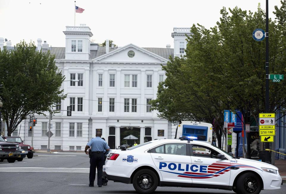A police vehicle is seen as police respond to a shooting at the Washington Navy Yard, in Washington, September 16, 2013. A gunman shot five people at the U.S. Navy Yard on Monday, including two law enforcement officers, and the shooter was being sought in a building housing the Naval Sea Systems Command headquarters, officials said. (REUTERS/Joshua Roberts)