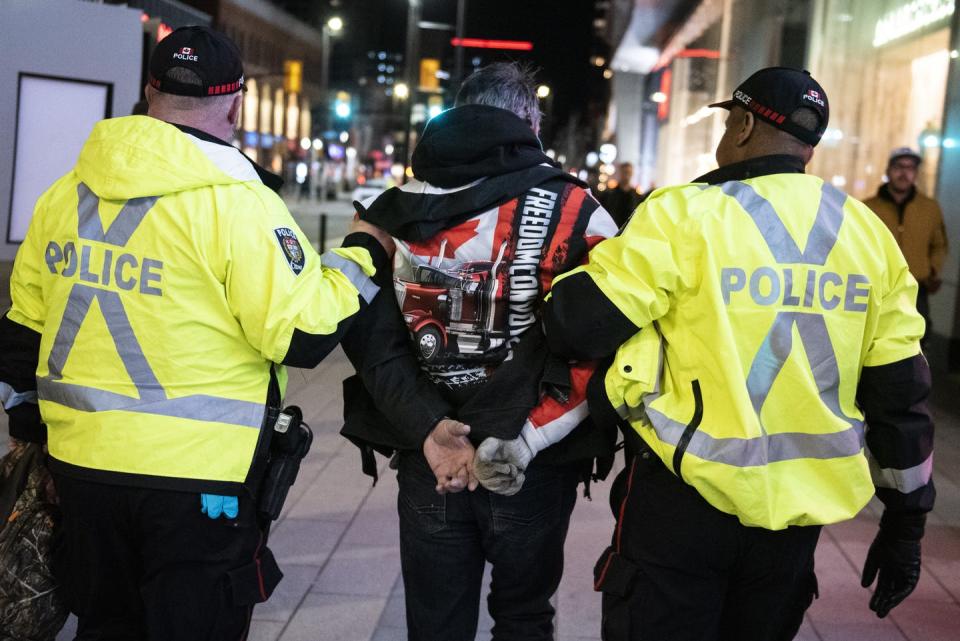 <span class="caption">Police take a person into custody as they worked to clear an area on Rideau Street during a convoy-style protest participants called ‘Rolling Thunder’ in Ottawa in April 2022.</span> <span class="attribution"><span class="source">THE CANADIAN PRESS/Justin Tang</span></span>