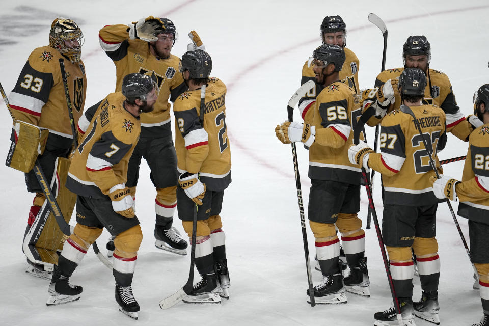 Vegas Golden Knights players celebrate after Game 1 of the NHL hockey Stanley Cup Finals against the Florida Panthers, Saturday, June 3, 2023, in Las Vegas. The Golden Knights defeated the Panthers 5-2. (AP Photo/Abbie Parr)