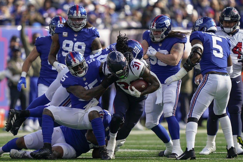 New York Giants linebacker Jihad Ward (55) tackles Houston Texans running back Dameon Pierce (31) during the first quarter of an NFL football game, Sunday, Nov. 13, 2022, in East Rutherford, N.J. (AP Photo/John Minchillo)