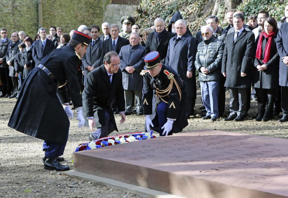 French President Francois Hollande lays a wreath at a memorial in the Mont Valerien in Suresnes, West of Paris, Friday Feb. 21, 2014, as part of an homage to French resistance members who fought during World War II, President Francois Hollande says two women who fought with the French Resistance during World War II will be inducted into Paris' renowned Pantheon, the eternal resting place of dozens of French greats.(AP Photo/Remy de la Mauviniere)