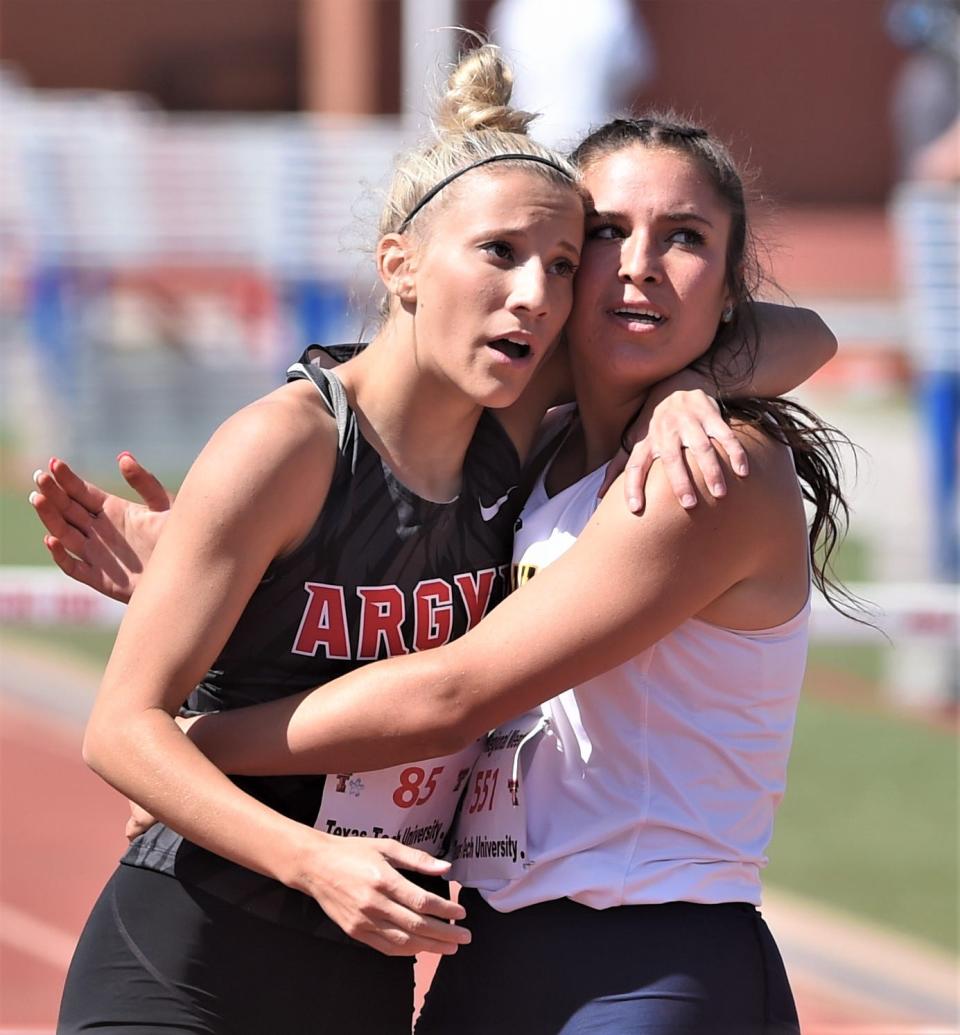 Stephenville's Jaylee Matthews, right, embraces Argyle's Sarah Runyon as the look at the Lowrey Field video board to see their times and finish. Runyon beat Matthews out for the second in the event with a 45.45 to Matthews' 45.68. Canyon's Abree Winfrey won it (45.13).