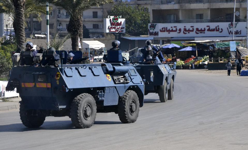 Lebanese police patrol on their military vehicles in the Sunni Muslim Bab al-Tebbaneh neighbourhood in Tripoli, northern Lebanon, February 20, 2014. Two people were killed in the Lebanese city of Tripoli on Thursday including Abdel Rahman Youssef, a military commander from the Alawite minority shot dead on his way to work, security sources said. REUTERS/Omar Ibrahim (LEBANON - Tags: CIVIL UNREST MILITARY POLITICS)