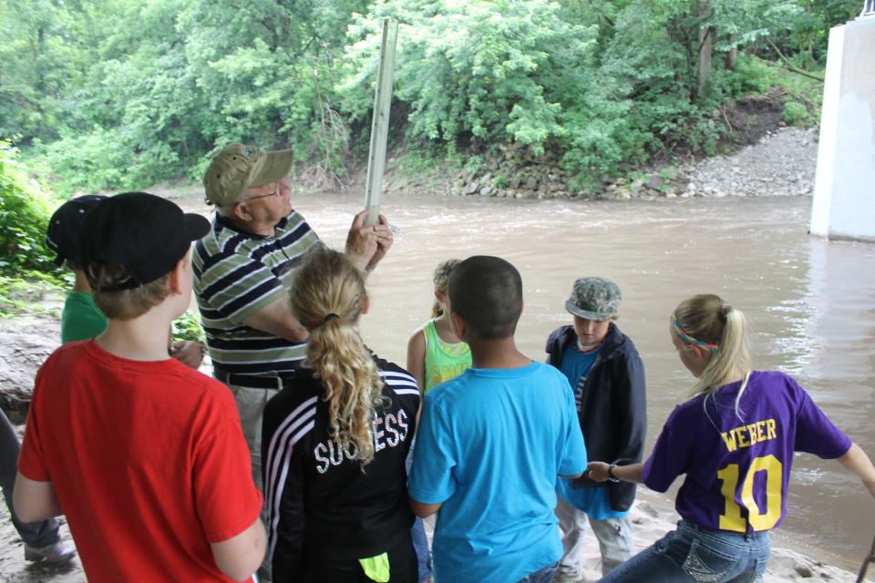 Erwin "Erv" Klaas teaching doing water testing with a group of kids in 2013.