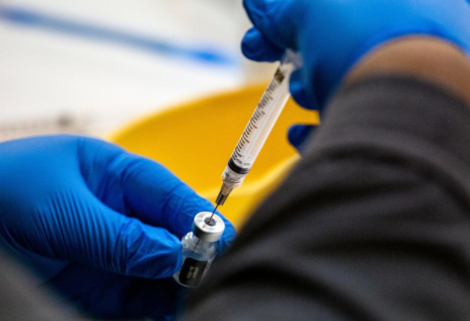 Registered nurse Patrice Holley prepares a dose of the Pfizer COVID-19 vaccine at a Riverside County run clinic in Indio, Calif., on February 10, 2021.  