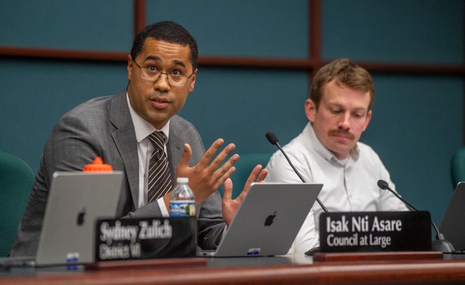 Isak Nti Asare speaks during the Bloomington City Council meeting at city hall on Wednesday, Jan. 10, 2024. To his left is council member Matt Flaherty.