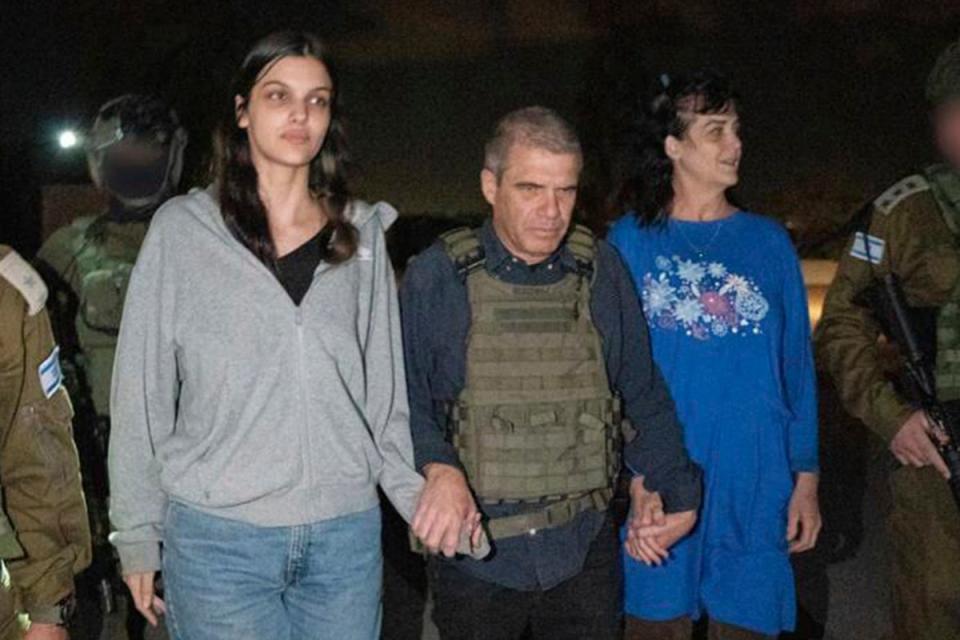 Judith Raanan, right, and her 17-year-old daughter Natalie are escorted by Israeli soldiers and Gal Hirsch, Prime Minister Benjamin Netanyahu's special coordinator for returning the hostages, as they return to Israel from captivity in the Gaza Strip (AP)