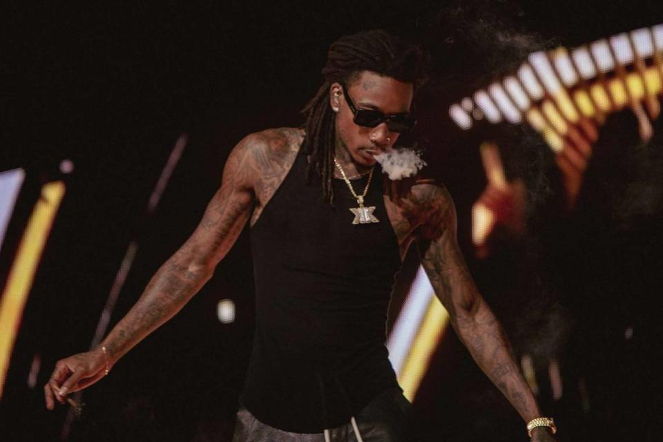 Wiz Khalifa blows smoke during his set in Charlotte.