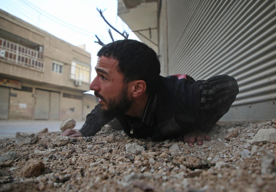 <p>A Syrian man reacts following an air strike in the rebel-held enclave of Arbin in the Eastern Ghouta near Damascus on Feb. 8, 2018. (Photo: Amer Almohibany/AFP/Getty Images) </p>