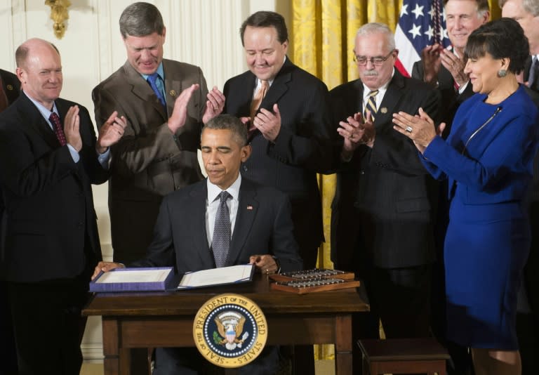 US President Barack Obama signs an act allowing him to negotiate trade treaties, including the TPP, in Washington DC on June 29, 2015