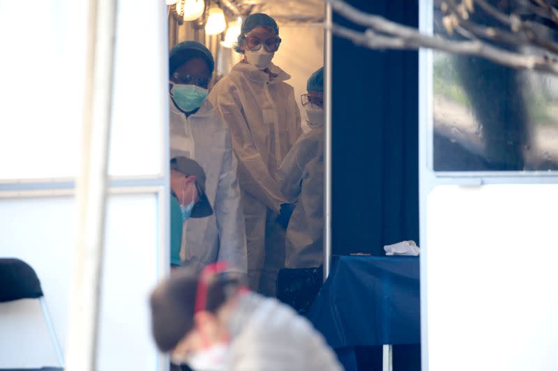 FILE PHOTO: Medical professionals see walk-in patients at a Covid-19 testing tent on the grounds of the George Washington University Hospital during the coronavirus disease pandemic in Washington