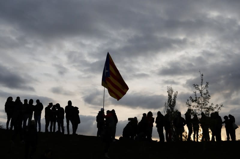 Demonstrators hold an Estelada as members of Catalan protest group Democratic Tsunami block the AP-7 highway in Girona