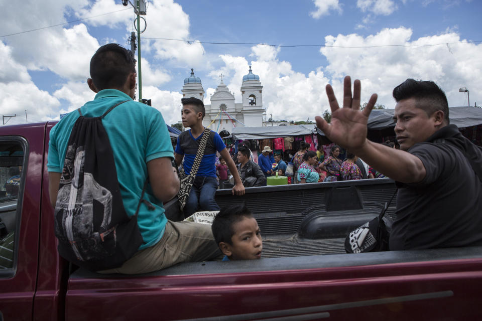 People ride on the bed of a pick-up truck towards the market in the central park of San Martin Jilotepeque, Guatemala, Sunday, August 4, 2019. People in Guatemala are now fearing an influx of Salvadoran or Nicaraguan migrants after their government signed a "third safe country" agreement with Washington. Such migration fears, poverty and corruption provide the backdrop to Guatemala's presidential runoff vote Sunday. (AP Photo/ Oliver de Ros)