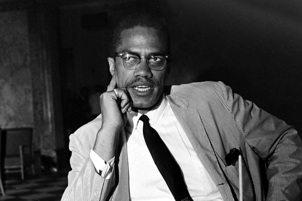 FILE — Malcolm X speaks at a news conference in the Hotel Theresa, in New York, May 21,1964. Two of the three men convicted in the assassination of Malcolm X are set to be cleared Thursday after insisting on their innocence since the 1965 killing of one of the United States' most formidable fighters for civil rights, Manhattan's top prosecutor said Wednesday, Nov. 17, 2021. Prosecutors now say authorities withheld evidence that favored the defense in the trial of Muhammad Aziz, now 83, and the late Khalil Islam. (AP Photo, File)