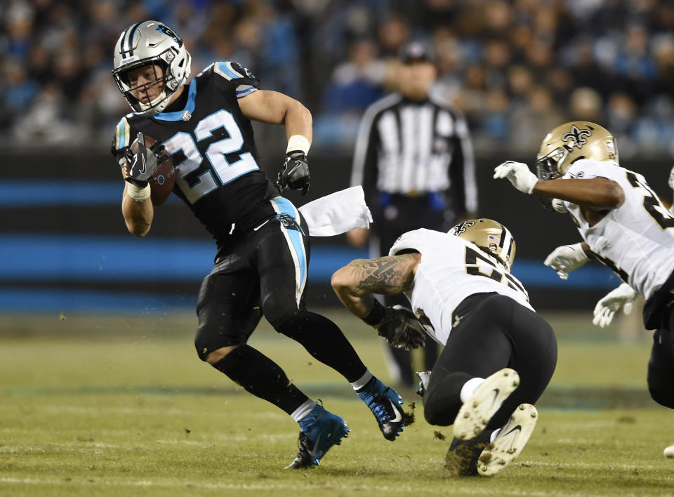 Carolina Panthers' Christian McCaffrey (22) evades a tackle by New Orleans Saints' A.J. Klein (53) in the first half of an NFL football game in Charlotte, N.C., Monday, Dec. 17, 2018. (AP Photo/Mike McCarn)