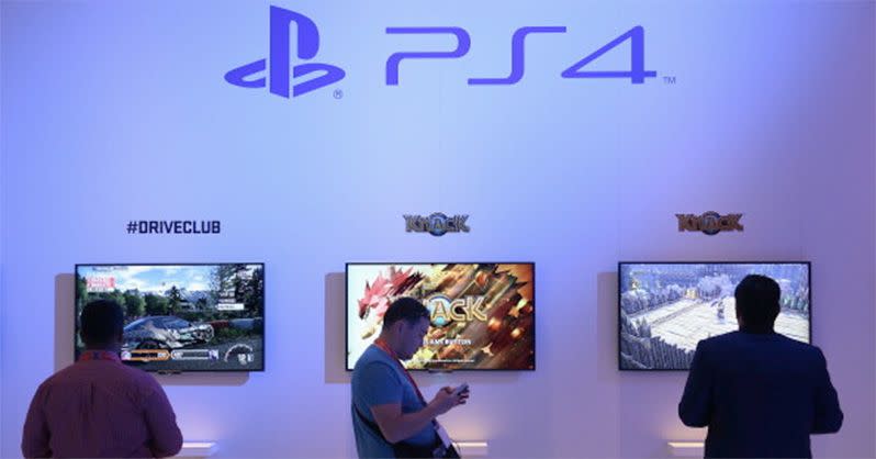 Visitors try out the PS4 gaming system at the Sony stand at the IFA 2013 consumer electronics trade fair in Germany. Photo: Getty.