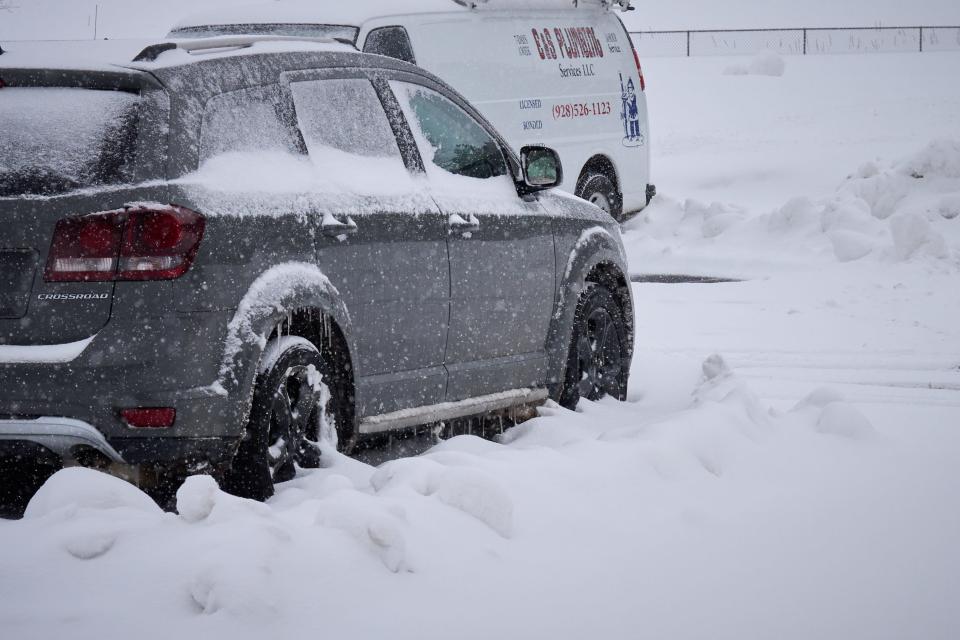 A parked vehicle continues to accumulate snow and icicles as snow falls at Raymond County Park in Flagstaff on Feb. 23, 2023.