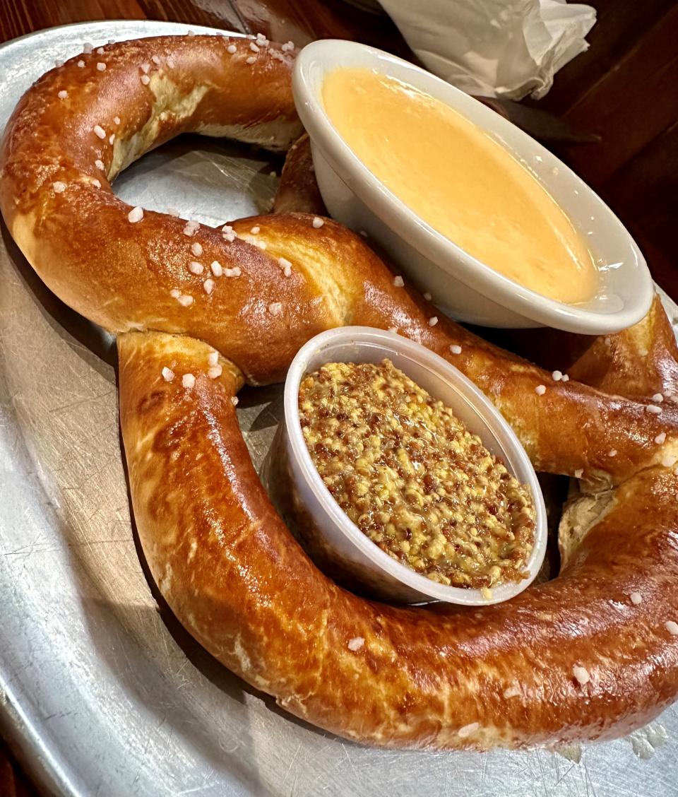 The Ginormous Pretzel at Tin Whiskey Southern Kitchen and Still in Cocoa Village is huge, served with a homemade cheese sauce and coarse-ground mustard.