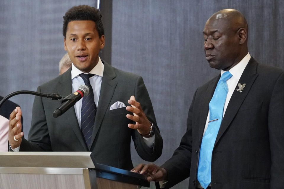 Former Northwestern quarterback Lloyd Yates, left, speaks as attorney Ben Crump, right, stands by at a news conference in Chicago, Monday, July 24, 2023. A hazing scandal at Northwestern has widened to include a volleyball player who on Monday became the first female athlete to sue the university over allegations she was retaliated against for reporting mistreatment and a new lawsuit by Yates. (AP Photo/Nam Y. Huh)