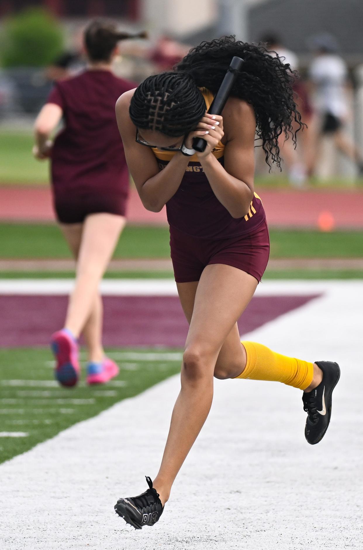 Bloomington North’s Dede Eberle celebrates after anchoring the 400 meter relay to a win during the track meet against Bloomington South at North on Wednesday, May 1, 2024.