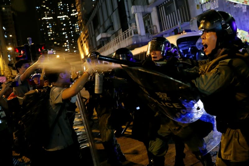 FILE PHOTO: Riot police use pepper spray to disperse anti-extradition bill supporters after police detained protesters near Sai Wan Ho Mass Transit Railway (MTR) station in Hong Kong