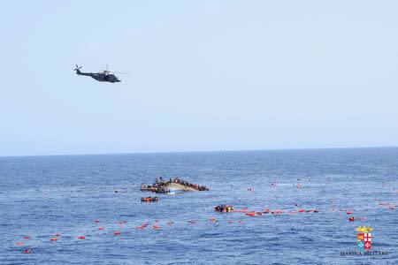 Migrants from a capsized boat are rescued during a rescue operation by Italian navy ships "Bettica" and "Bergamini" off the coast of Libya in this handout picture released by the Italian Marina Militare on May 25, 2016. Marina Militare/Handout via REUTERS