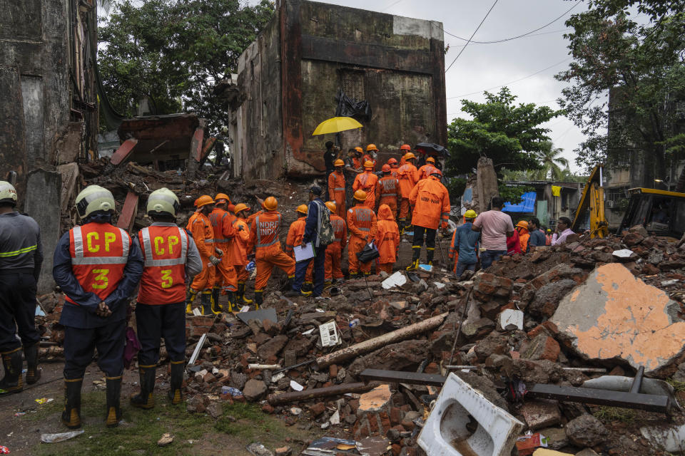 Rescuers look for survivors in the debris of a four-story residential building that collapsed in Mumbai, India, Tuesday, June 28, 2022. At least three people died and more were injured after the building collapsed late Monday night. (AP Photo/Rafiq Maqbool)