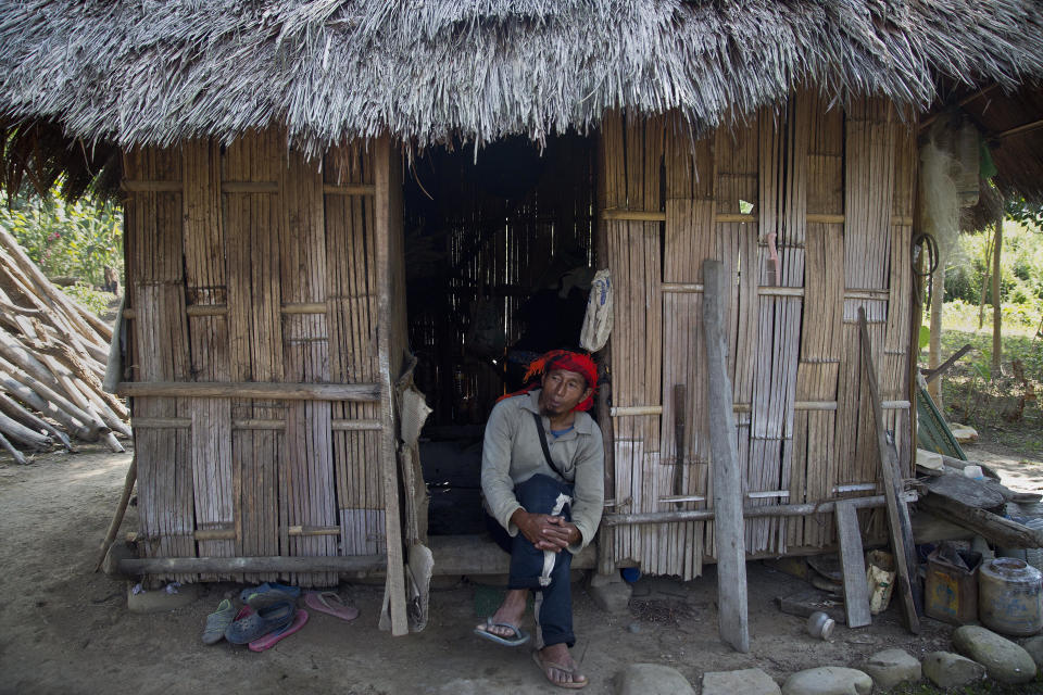 In this Saturday, Nov. 10, 2018, photo, Renkey Humtsoi, 48, hunter-turned-conservationist, rests in his hut by a farm near Pangti village in Wokha district, in the northeastern Indian state of Nagaland. The 8,000 residents of a remote tribal area in northeastern India are passing through extremely hectic days, playing hosts to millions of the migratory Amur Falcons from Siberia who roost by a massive reservoir before they take off to their final destination—Somalia, Kenya, and South Africa, traversing 22,000 kilometers. (AP Photo/Anupam Nath)