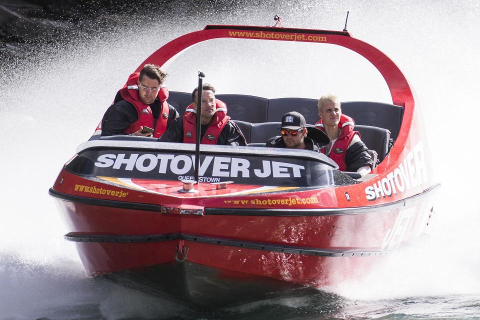 Biebs boards a boat and looks, well bored...