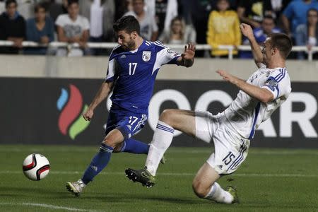 Cyprus' George Efrem fights for the ball with Bosnia's Toni Sunjic during their Euro 2016 group B qualification match at the GSP stadium in Nicosia, Cyprus October 13, 2015. REUTERS/Yiannis Kourtoglou