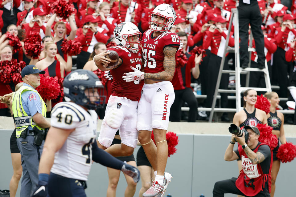 North Carolina State's Anthony Smith (85) congratulates Jordan Houston (3) on his touchdown during the first half of an NCAA college football game against the Charleston Southern in Raleigh, N.C., Saturday, Sept. 10, 2022. (AP Photo/Karl B DeBlaker)