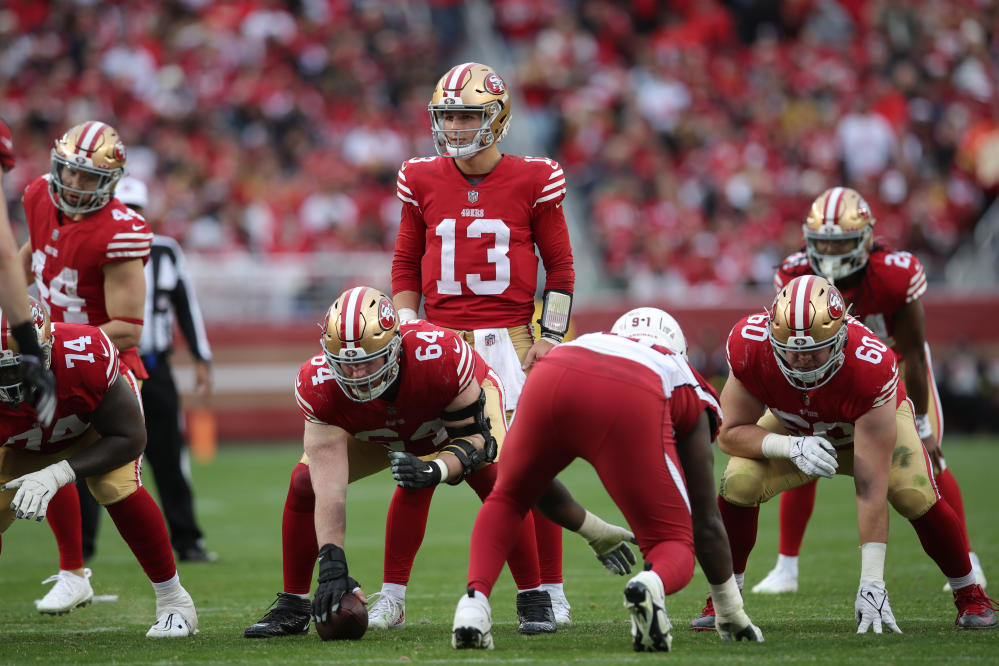 San Francisco 49ers quarterback Brock Purdy jukes and jives past defenders  on 18-yard scramble