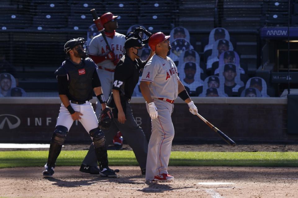 Angels' Albert Pujols watches his two-run home run to take the lead against the Colorado Rockies.