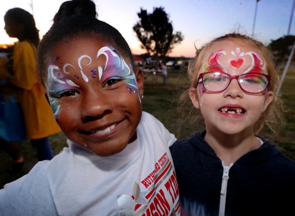 Friends Jhuri Cook, 8, and Emma Fielder, 6, show off their painted faces during the National Night Out in La Vergne, on Tuesday, Oct. 4, 2022, at Veterans Memorial Park.