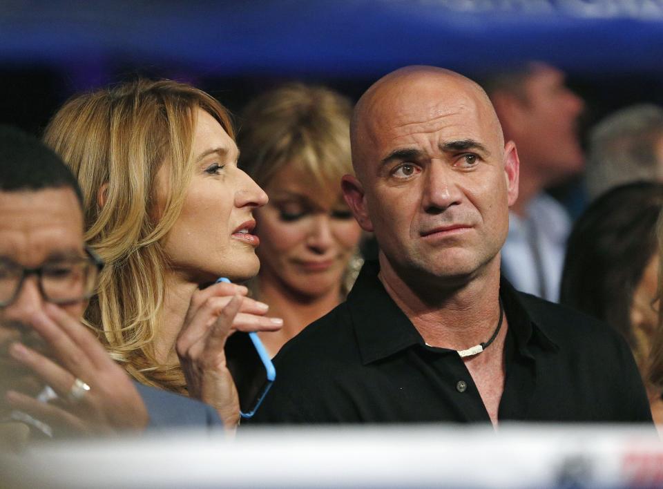 Steffi Graf, left, and Andre Agassi join the crowd before the start of the world welterweight championship bout between Floyd Mayweather Jr., and Manny Pacquiao, on Saturday, May 2, 2015 in Las Vegas. (AP Photo/John Locher)