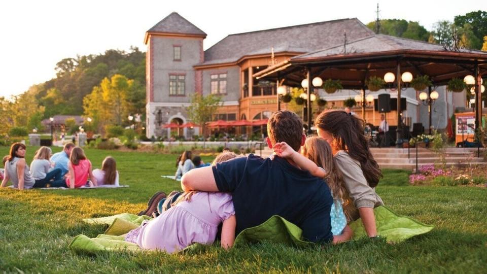 Families lounging on Village Green in Antler Hill Village.
