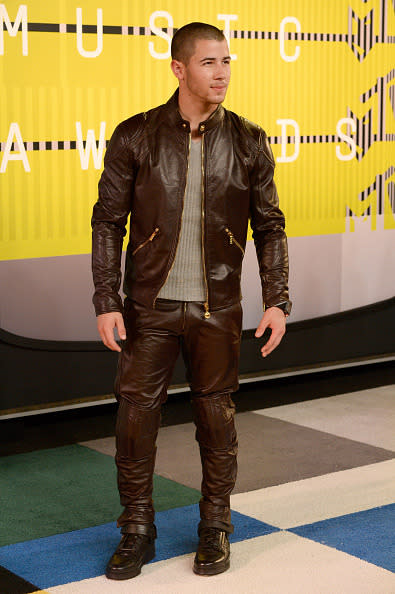 <p>Nick Jonas, who performed his new single “Levels” during the pre-show, looked like he stepped off of a motorcycle and onto the step-and-repeat with his shaved head, leather jacket, and boots. (Photo: Getty Images)</p>