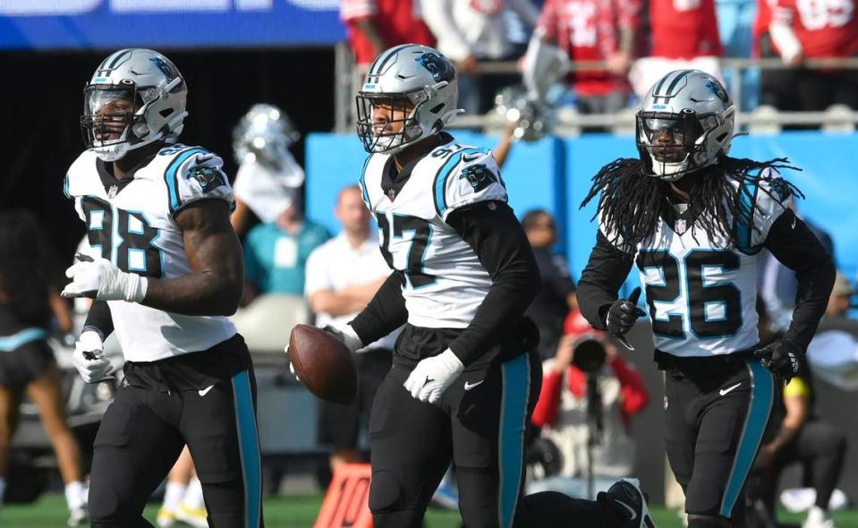 Carolina Panthers defensive end Yetur Gross-Matos, center, runs across the field after recovering a fumble by the San Francisco 49ers during first quarter action at Bank of America Stadium on Sunday, October 9, 2022.